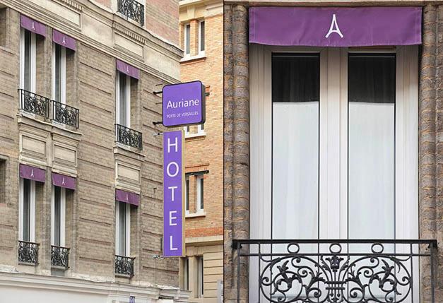パリにあるオーリアン ポルト ドゥ ヴェルサイユの紫の看板が横に建つ建物