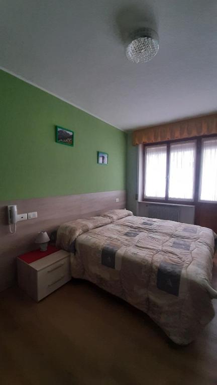 Postel nebo postele na pokoji v ubytování Albergo Bar Ristorante Da Gina