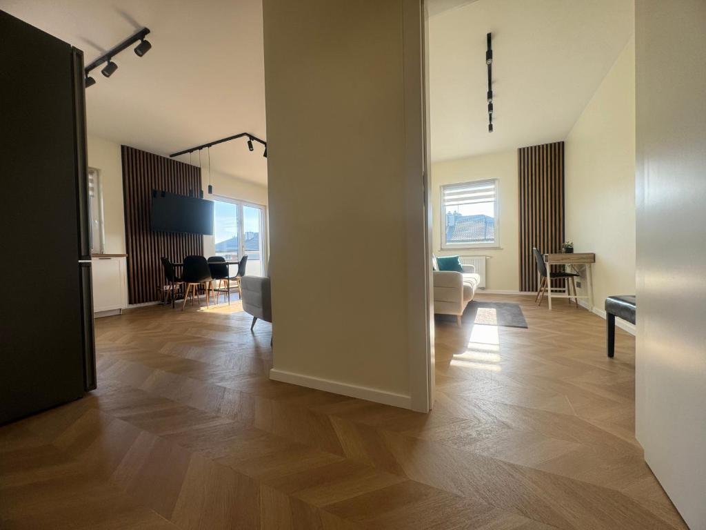 an open room with a living room and a dining room at Stylish 3 bedroom apartment with balcony in Płock