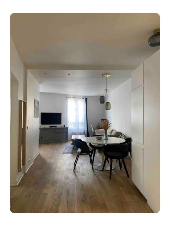 un salon avec une table et une salle à manger dans l'établissement Appartement cosy à Paris, à Paris