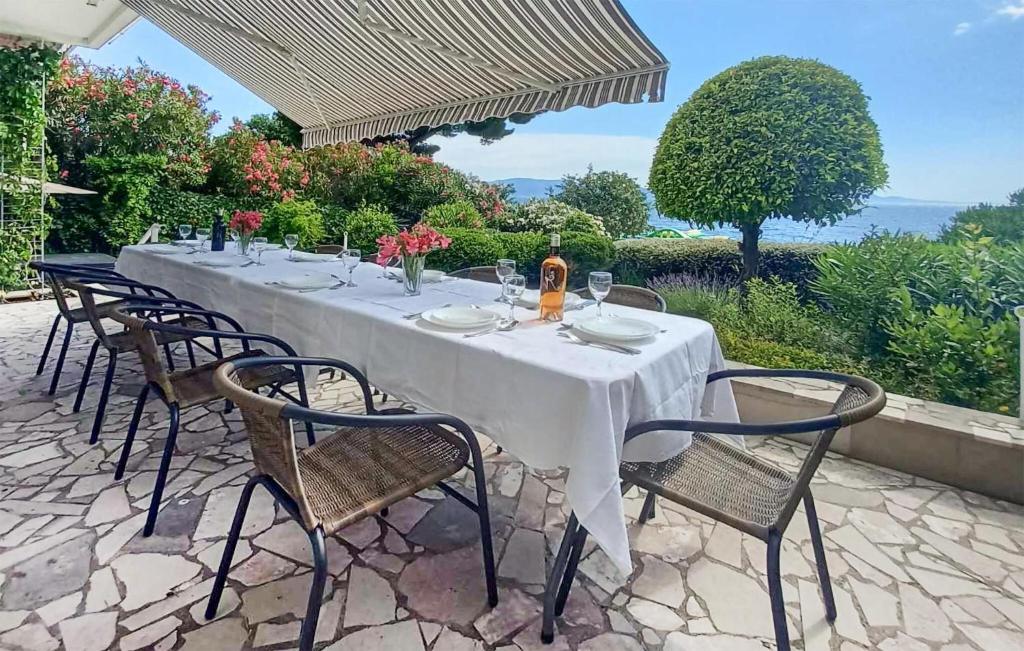 a long table with chairs and a white table cloth at Beach Front Home In Gradac With House Sea View in Gradac