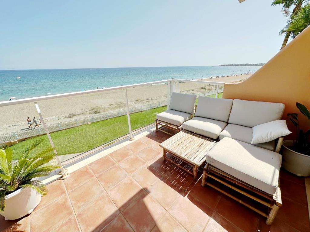 a patio with a couch and a view of the beach at Mirador al Mar 32 in Denia