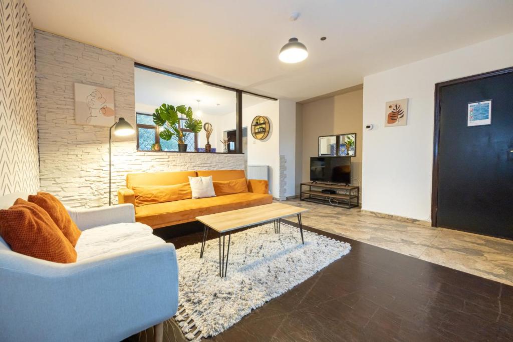 a living room with a couch and a table at GuestReady - Stainton Retreat in Manchester