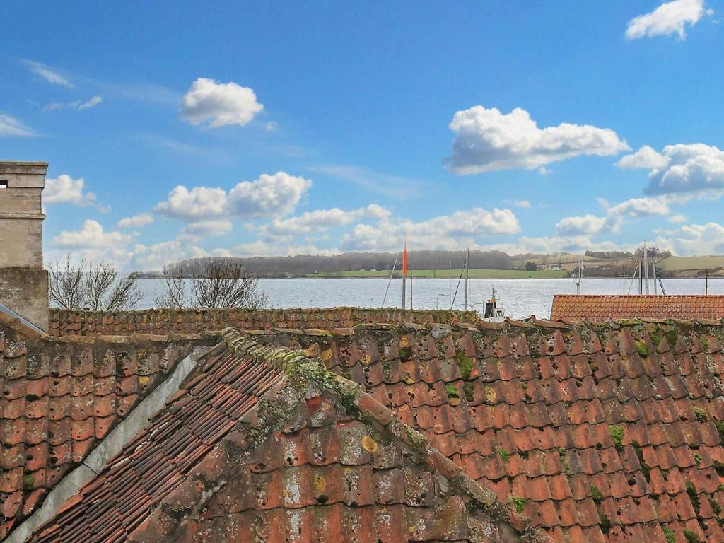 a group of roofs with water in the background at Holiday home Faaborg XXVII in Fåborg