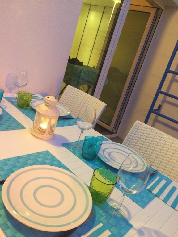 a table with plates and wine glasses on it at Odeceixe Vila in Odeceixe
