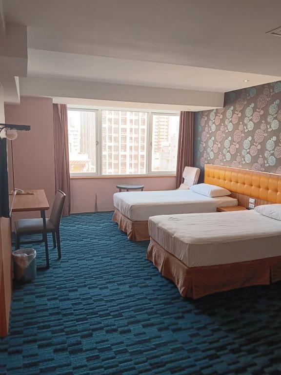 En eller flere senger på et rom på Yiting Hotel