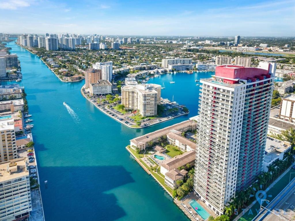 an aerial view of a city with a river and buildings at Modern Resort - Apartment with Balcony, Pool and Gym in Hallandale Beach