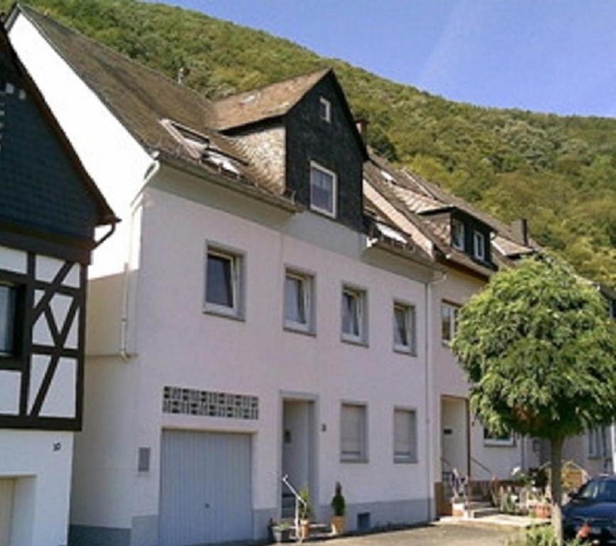a large white house with a grass roof at Ferienhaus Loreleytal in Boppard