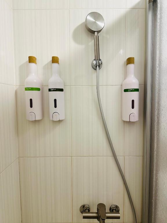 a bathroom with three bottles of bleach on the wall at Yurong B&amp;B in Magong