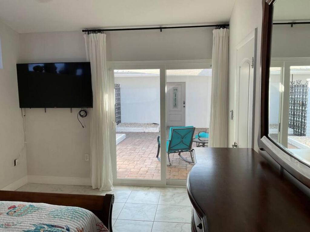 a bedroom with a bed and a flat screen tv at Punta Gorda Getaway - Close to the airport and downtown in Punta Gorda