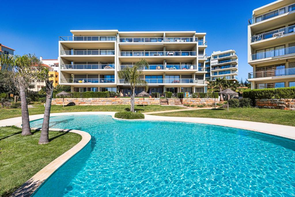 a swimming pool in front of a apartment building at Oásis Mar - Beach and Sun House in Portimão
