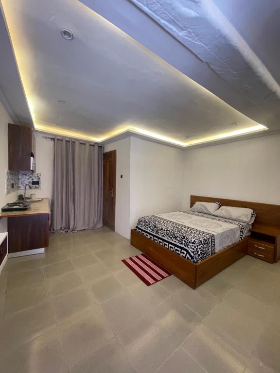 a bedroom with a bed and a ceiling at One Aquarium Inn in Cape Coast