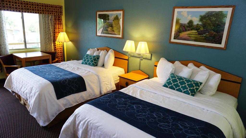 a hotel room with two beds with blue walls at Virginia Inn in Lawrence