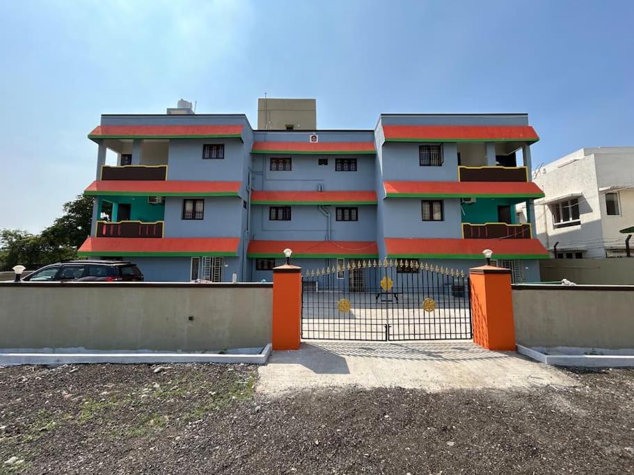 a building with a fence in front of it at The Sweet Home in Chennai