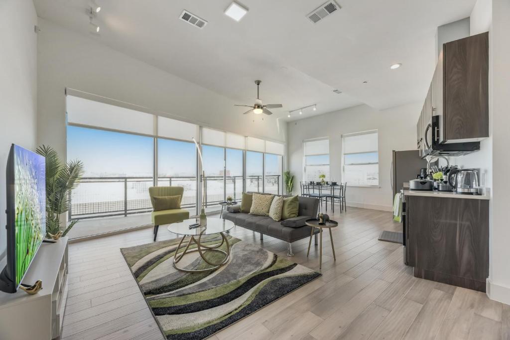 a living room and kitchen with a view of the ocean at Contemporary 2BR I Gym I Parking I Workspace in Dallas