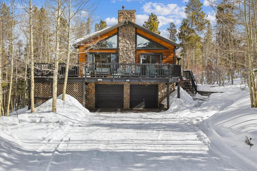 a log cabin in the woods in the snow at Wildwood Peaks home in Breckenridge