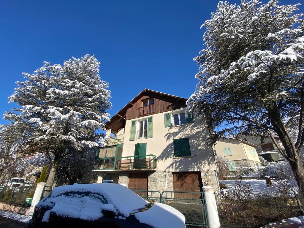 a snow covered house with a car in front of it at Villa Meyronnes 3 chambres vue degagée montagnes in Barcelonnette