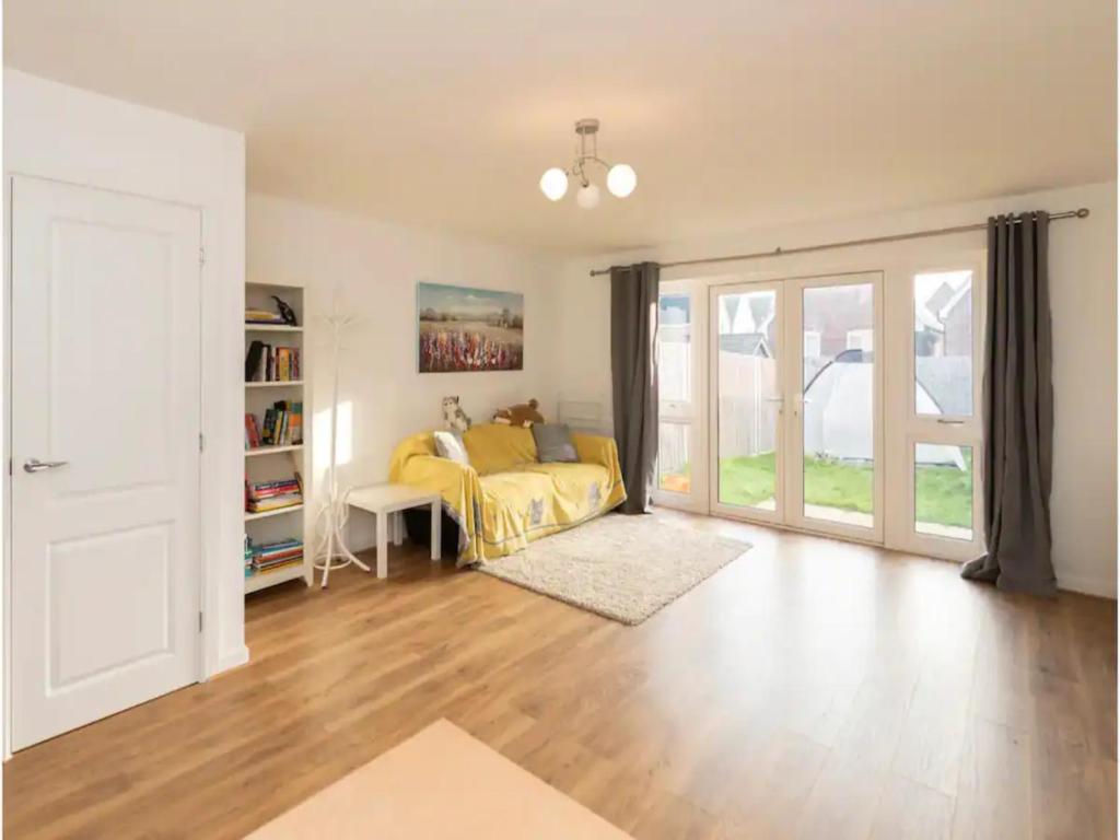 a bedroom with a bed and a book shelf at Pass the Keys Semi-detached house with garden and free parking in Shinfield