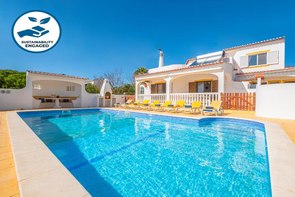 a villa with a swimming pool and a house at Villa Renaissance by Algarve Vacation in Carvoeiro