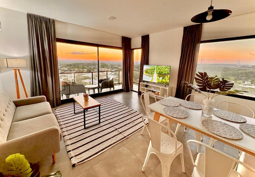 a living room with a couch and a table at Apartamento centrico con vistas panoramicas Puerto Iguazu in Puerto Iguazú
