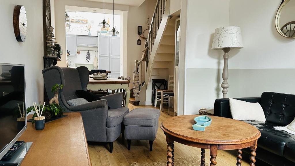 a living room with a couch and chairs and a table at Maison Ma Bohème, 250m de la mer in Cayeux-sur-Mer