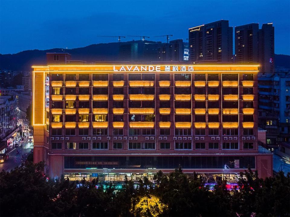 a large building with a lit up sign on it at Lavande Hotel Guangzhou Shatai South Road Tianpingjia Metro Station in Guangzhou