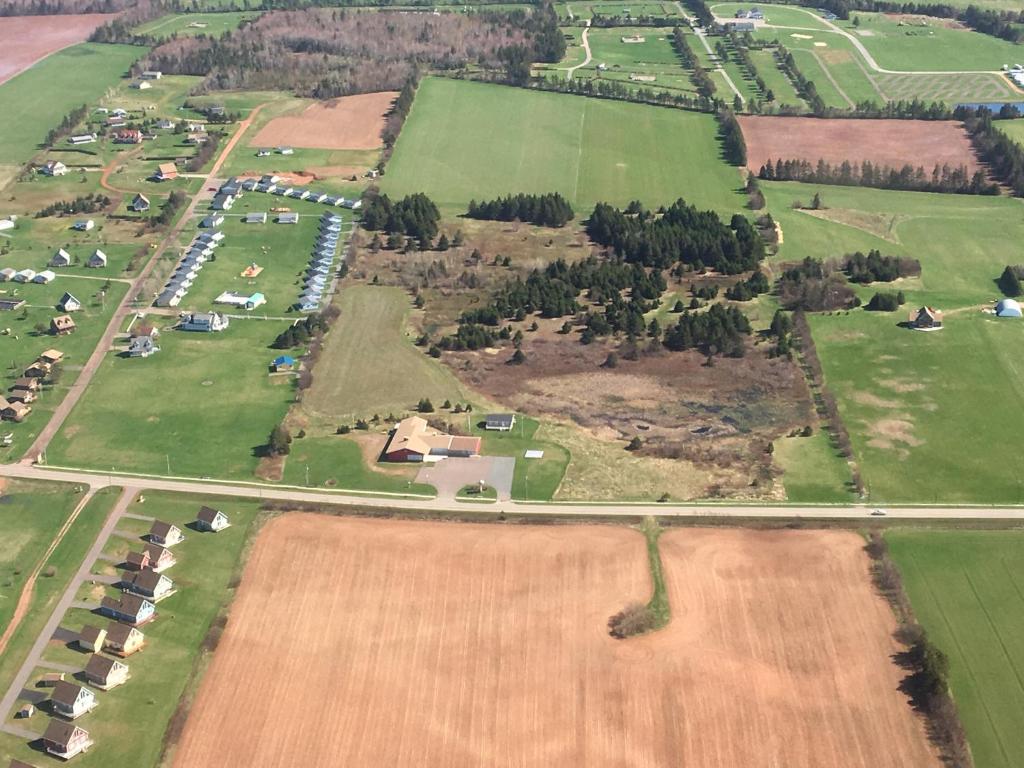 an aerial view of a farm with fields and a road at Wood Duck Cottage in Cavendish