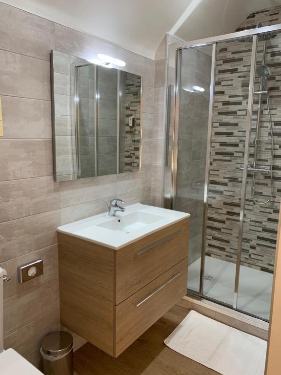 a bathroom with a sink and a shower at La Bonbonniere - Sure Hotel Collection by Best Western in Dijon