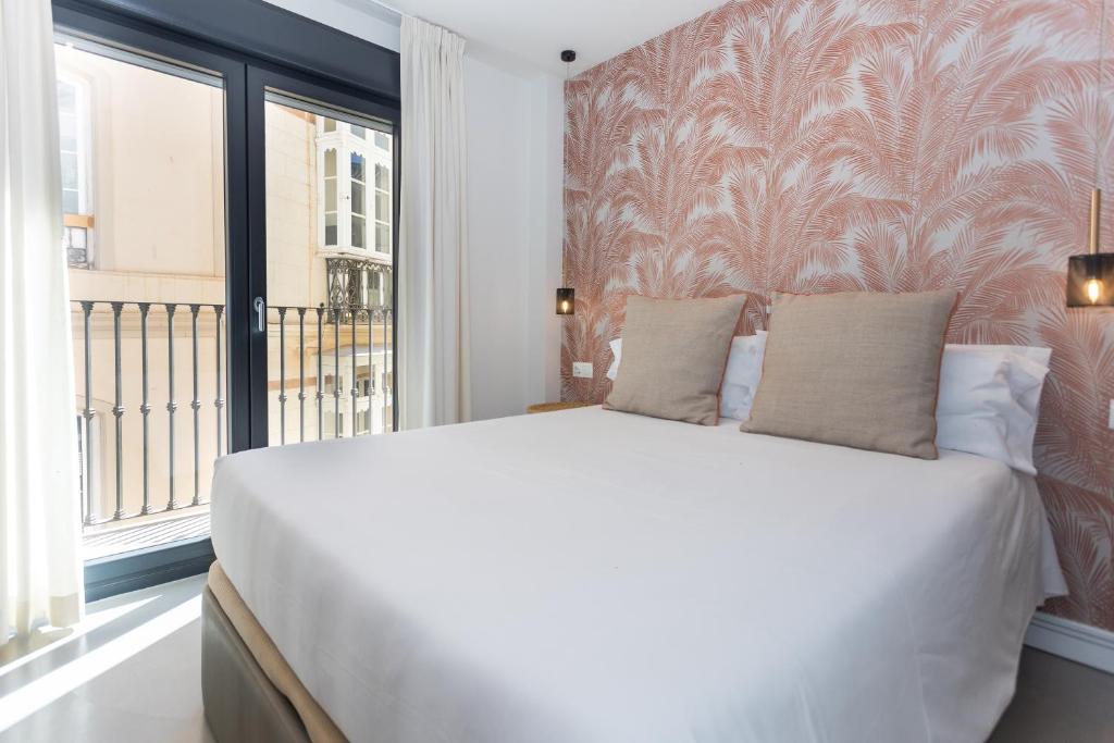 Postel nebo postele na pokoji v ubytování Apartamentos 7 dreams