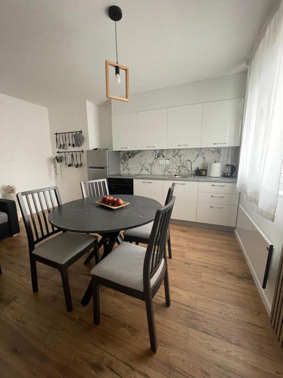 a dining room table and chairs in a kitchen at Trevi u Liku in Gospić