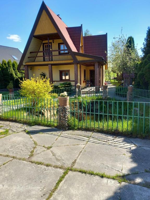 a fence in front of a house at DOM do wynajęcia Kruszewnia/Morąg in Morąg