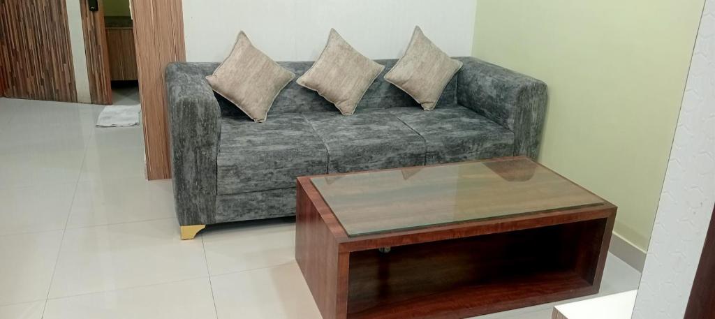 a living room with a couch and a coffee table at Xanadu studio Appartment 904 in kolkata