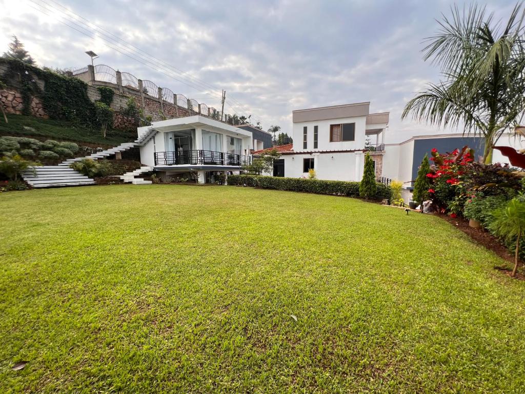 a house with a large lawn in front of it at Prayer Mountain Cove in Kampala