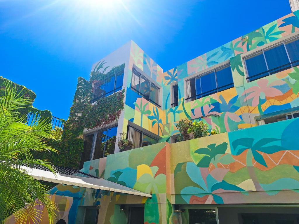 a building with a colorful mural on the side of it at Fuxia Jungle Hostel in Mendoza