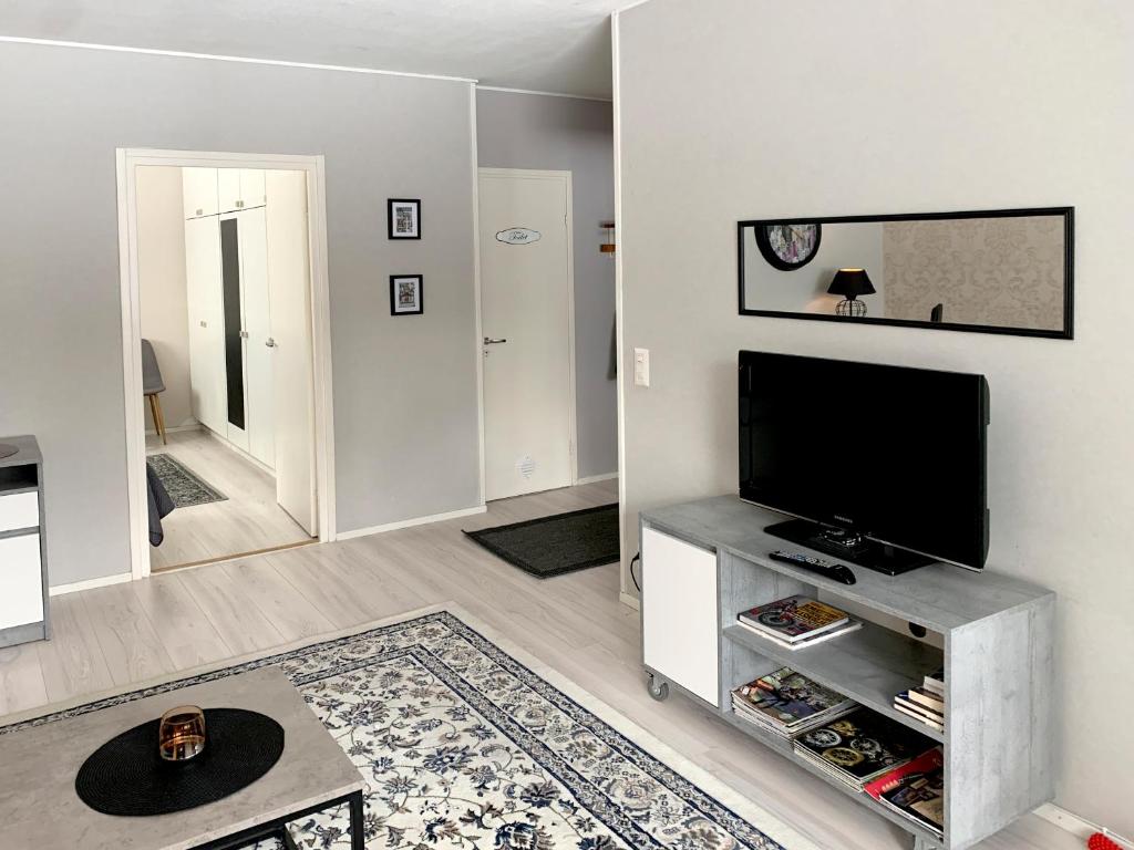a living room with a flat screen tv at Apartment Ryti in Kokkola