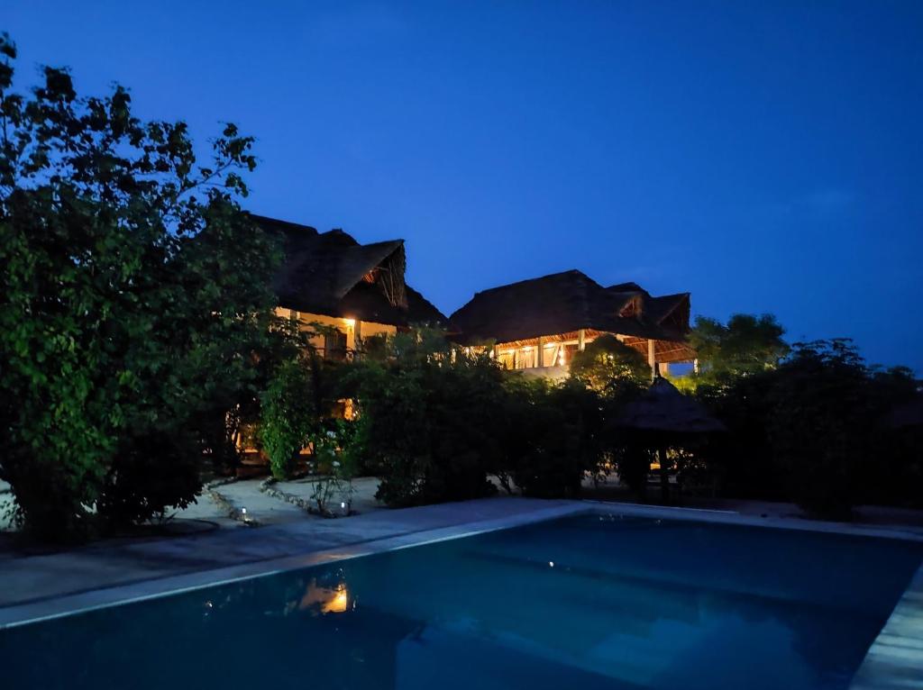 Villa con piscina por la noche en SECRET PLACE HOTEL by HELLO TANZANIA TOURS& SAFARIS, en Makunduchi