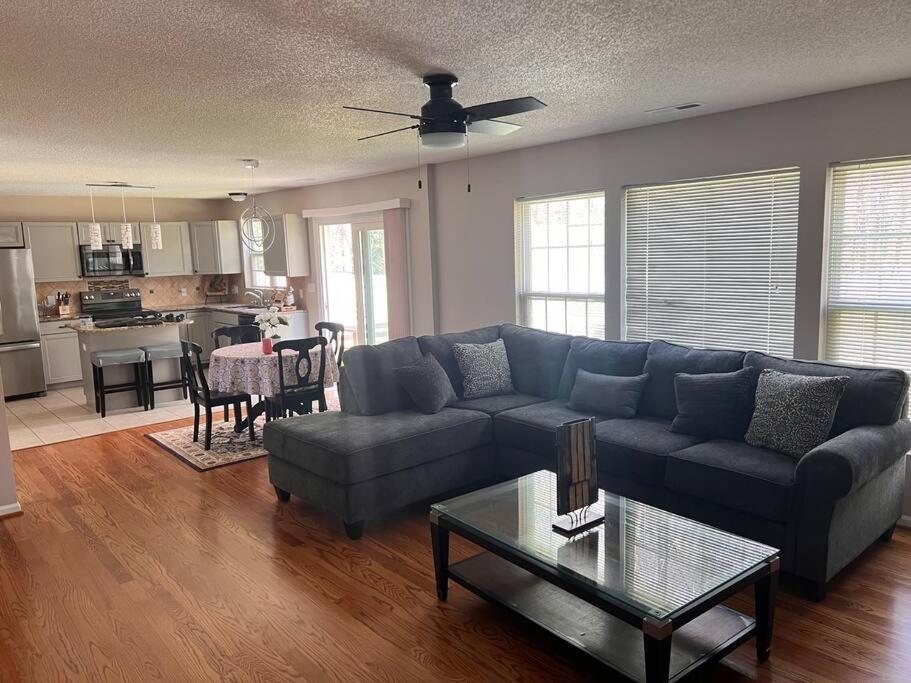 a living room with a couch and a table at A spacious and warm house in Fuquay-Varina