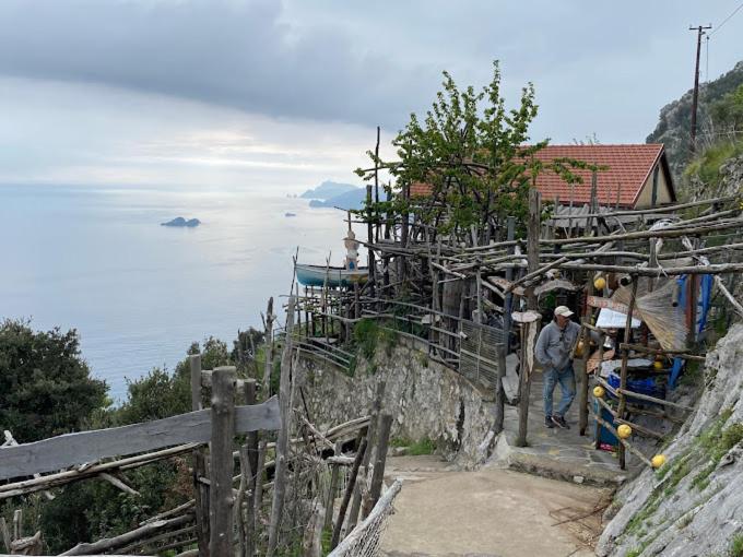 a man standing on the side of a mountain at Ulisse sul Sentiero in Praiano