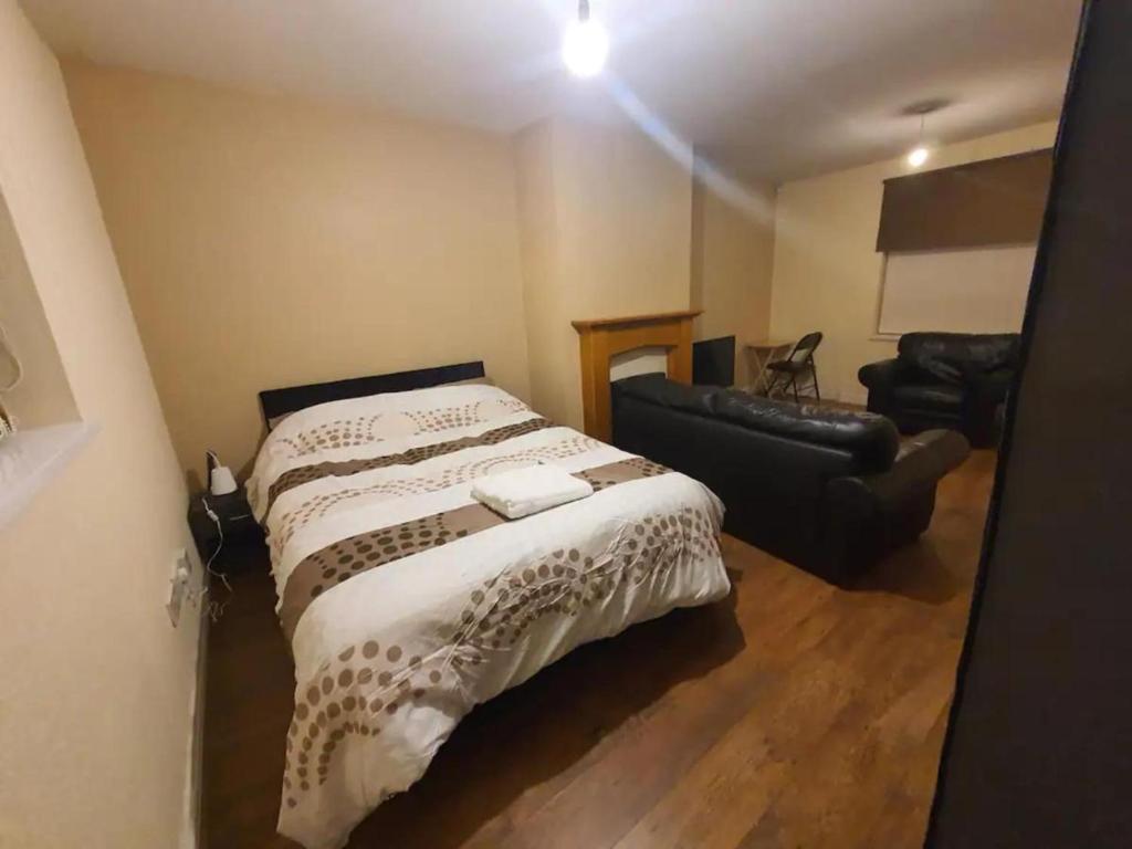 a bedroom with a large bed and a couch at Double Bedroom TDA Greater Manchester in Middleton