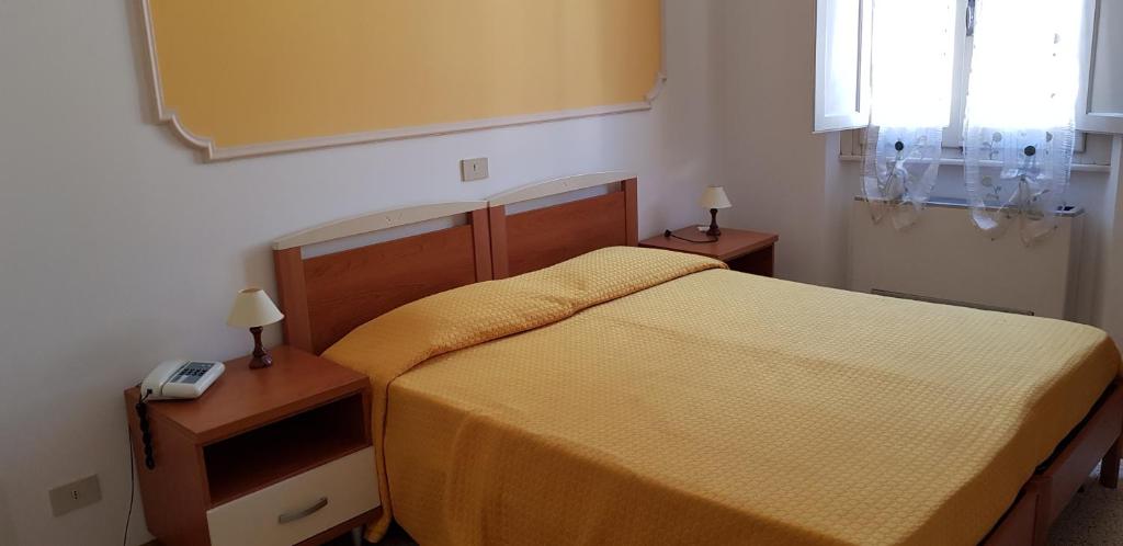 Postel nebo postele na pokoji v ubytování Albergo Natucci
