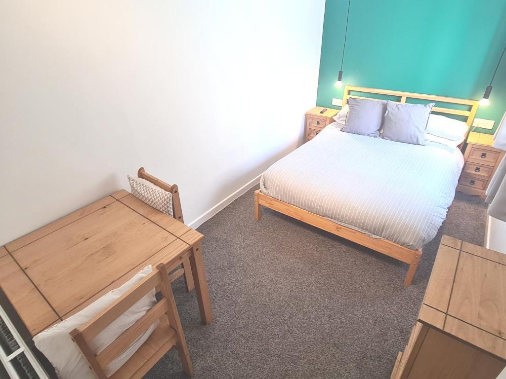 a small bedroom with a bed and a table at Five-star apartment in London