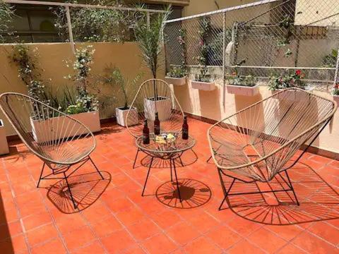 two chairs and a table on a patio at Gem! New Condo 4 Blocks From Puerto Madero in Buenos Aires