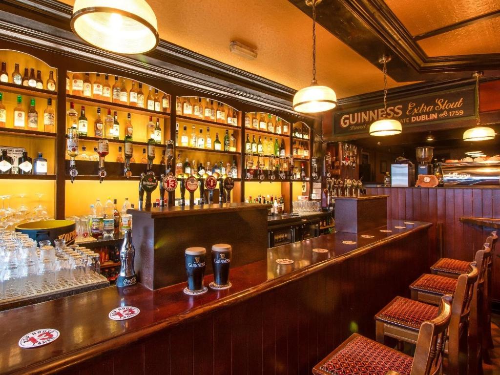 a bar with a lot of bottles of alcohol at Kingston's Townhouse in Killorglin