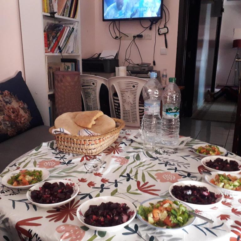 a table with plates of food and bottles of water at ديار المنصور بني ملال المغرب in Beni Mellal
