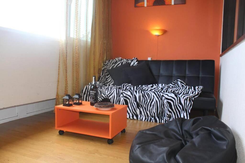 a living room with a couch with zebra printed sheets at Apartamento Matur in Santa Cruz