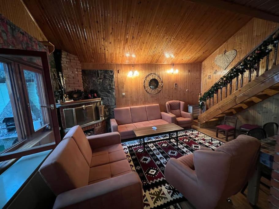 a large living room with couches and a staircase at Chalet Hilltop Kodra e Diellit Popovo Sapka in Tetovo