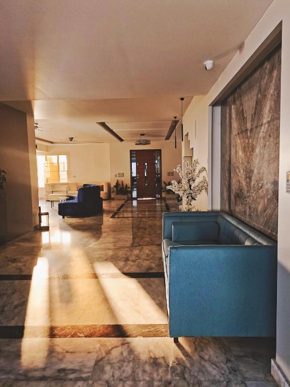a large living room with a couch and a table at Aurora sky view suite in Sheikh Zayed