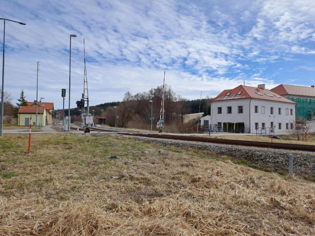 a field of grass next to a train track at Loft Polná in Boletice