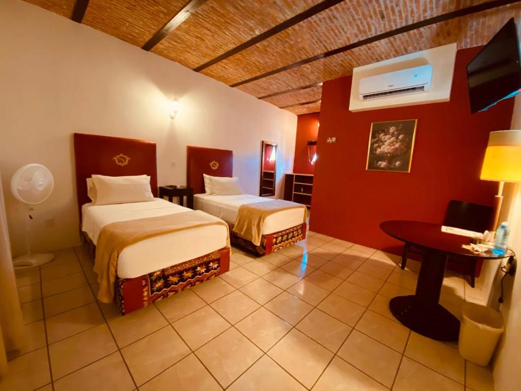 Postel nebo postele na pokoji v ubytování Hotel & Eventos Xalos