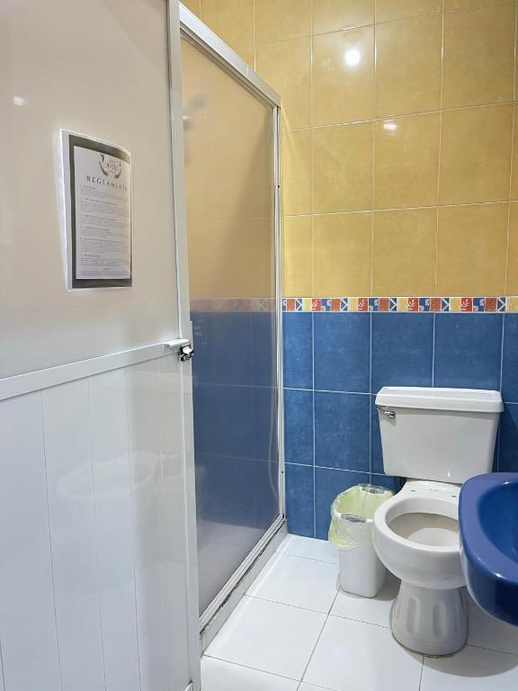 a bathroom with a shower and a toilet at Gran Hotel Tlaxiaco in Heroica Ciudad de Tlaxiaco